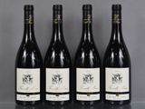 three bottles of wine are lined up on a table