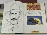 an open book with a drawing of a man in a hat and a car in the background