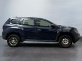 a picture of a blue suv parked in a garage