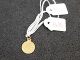 a close up of a gold coin on a string with a price tag