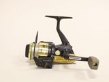 a close up of a spinning reel on a white surface
