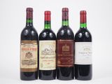 four bottles of wine are lined up on a white surface