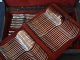 a wooden box with silverware in it on a table