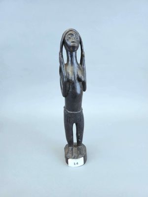 une petite statue représentant une femme tenant sa tête entre ses mains