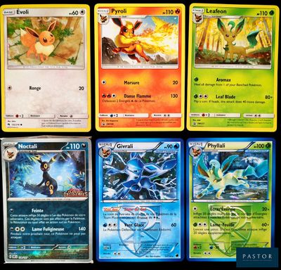 Plusieurs cartes Pokémon différentes sont disposées sur une surface noire