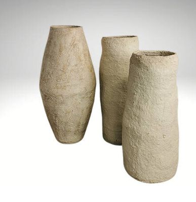 three vases sitting next to each other on a white surface