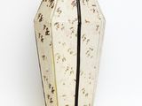 beige and black vase on a white background with a black stripe