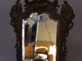 a mirror that is sitting on a table next to a couch