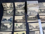 a lot of old postcards that are on a table