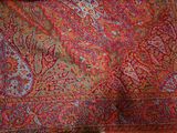 a red and blue paisley pattern on a red and blue blanket