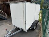 a trailer with a trailer attached to it in a parking lot