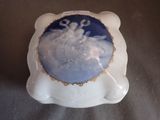 a blue and white plate with a picture of a snowman on it