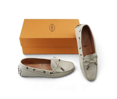 a pair of white shoes with a box on the side