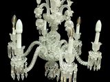 a crystal chandelier with five lights hanging from it