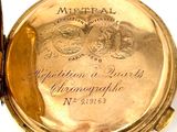 a gold pocket watch sitting on a white surface