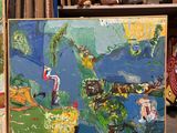 un tableau posé par terre, à côté d'un tableau accroché au mur