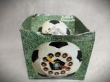 a soccer ball inside of a box with a clock on it