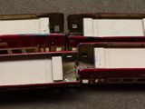 three red and black toy trains sitting on the floor