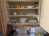 a kitchen with a lot of dishes and dishes on the counter