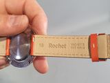 a person holding a watch in their hand