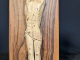 carved wooden crucifix of jesus on a cross on a black background