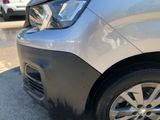 a close up of a car ' s front bumper with a denting on it