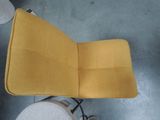 a yellow chair that is sitting in the middle of a room