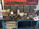 a workbench with a lot of tools on top of it