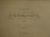 an old book with writing on it sitting on a table