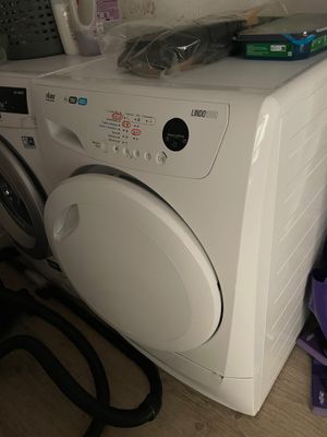 a washer and dryer sitting on the floor next to each other