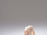 a close up of a ring on a white surface with a white background
