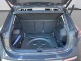 the back of a car with the trunk open and the seat down