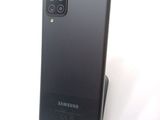 the back of a black samsung galaxy s20 with a camera attached to it
