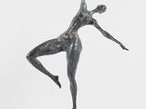 statue of a female dancer on a pedestal on a white background