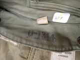 a close up of a green pants with a tag on it