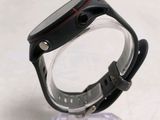 a close up of a watch on a clear stand
