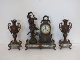 three antique clocks sitting next to each other on a table
