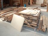 many pieces of wood stacked on the floor in a room
