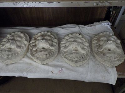 four stone heads are sitting on top of a sheet of paper