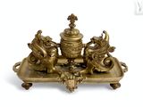 brass figurine of three lions on a tray with a cross on top