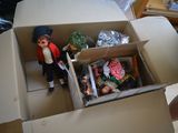 a cardboard box with a doll in it and a doll in it