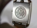 a close up of a watch on a white surface