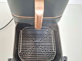 an image of a toaster with a basket on top of it