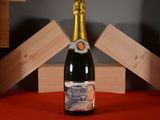 a bottle of champagne sitting on a table with wooden blocks