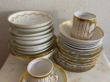 a lot of plates and cups on the table