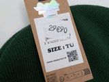 a green hat with a price tag attached to it
