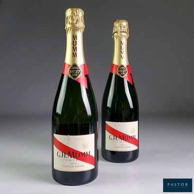two bottles of champagne sitting next to each other on a table