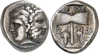 a close up of a silver coin with a face on it