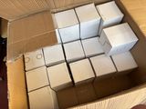 a box full of white boxes sitting on the floor