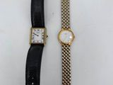 a couple of watches sitting next to each other on a table